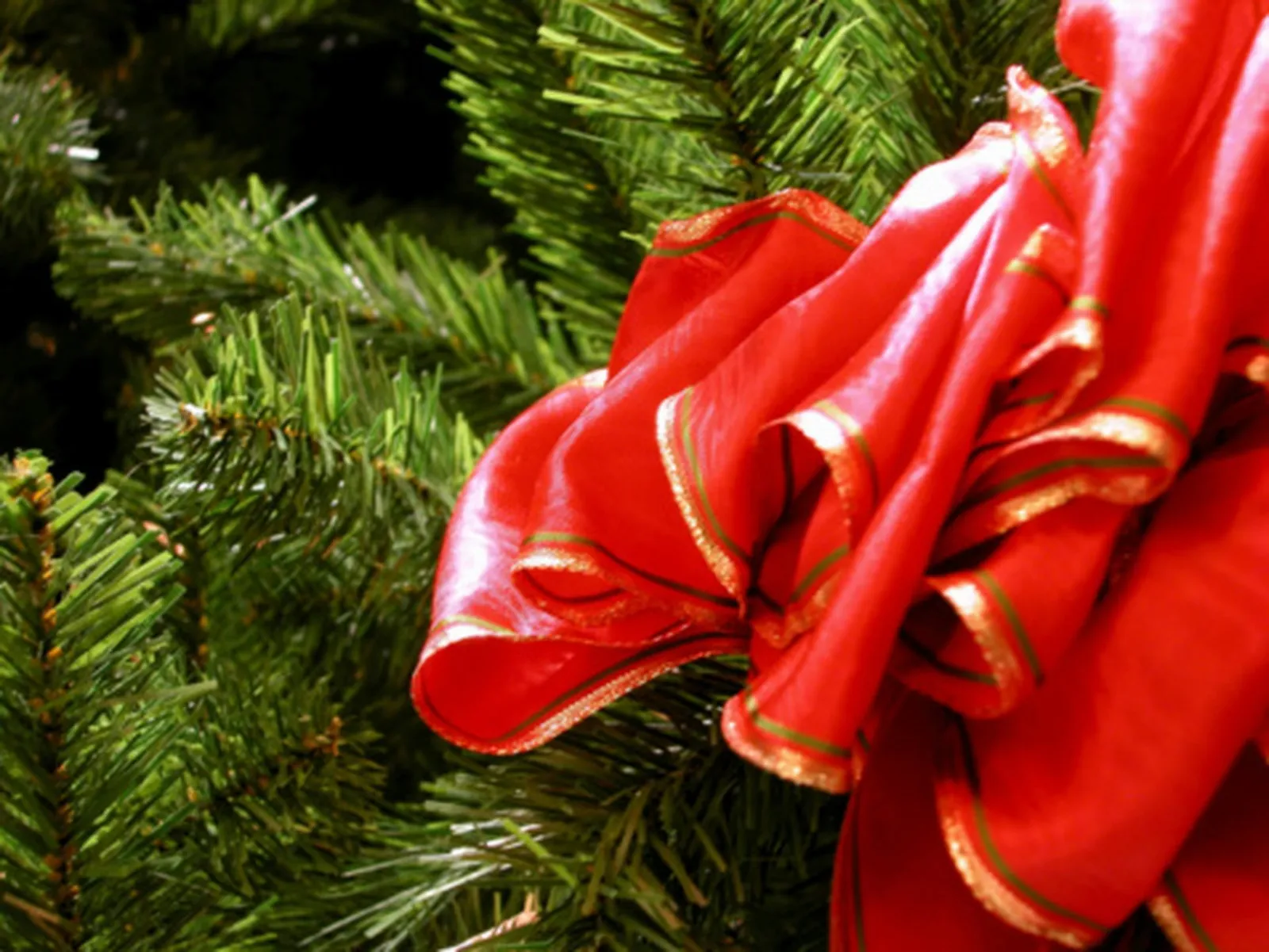 Weave a ribbon through a wreath to enhance a holiday theme.
