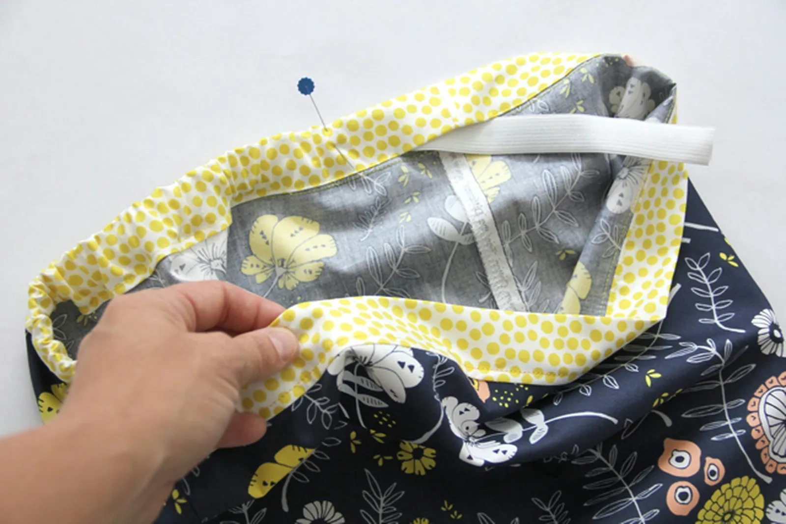 Pin the other end of the elastic in place so that it doesn't slip into the casing