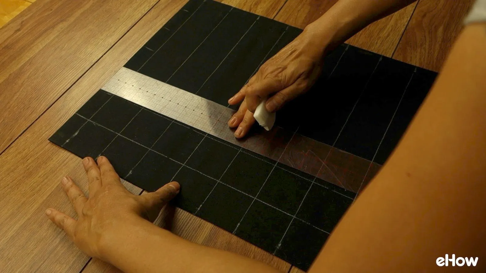 Drawing chalk guidelines for DIY mudcloth-inspired wall hanging.