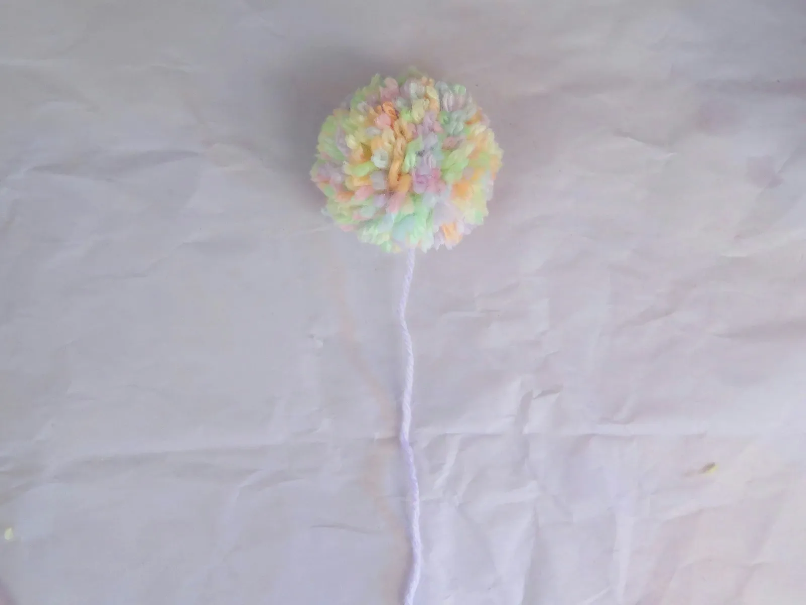 A finished yarn pompom