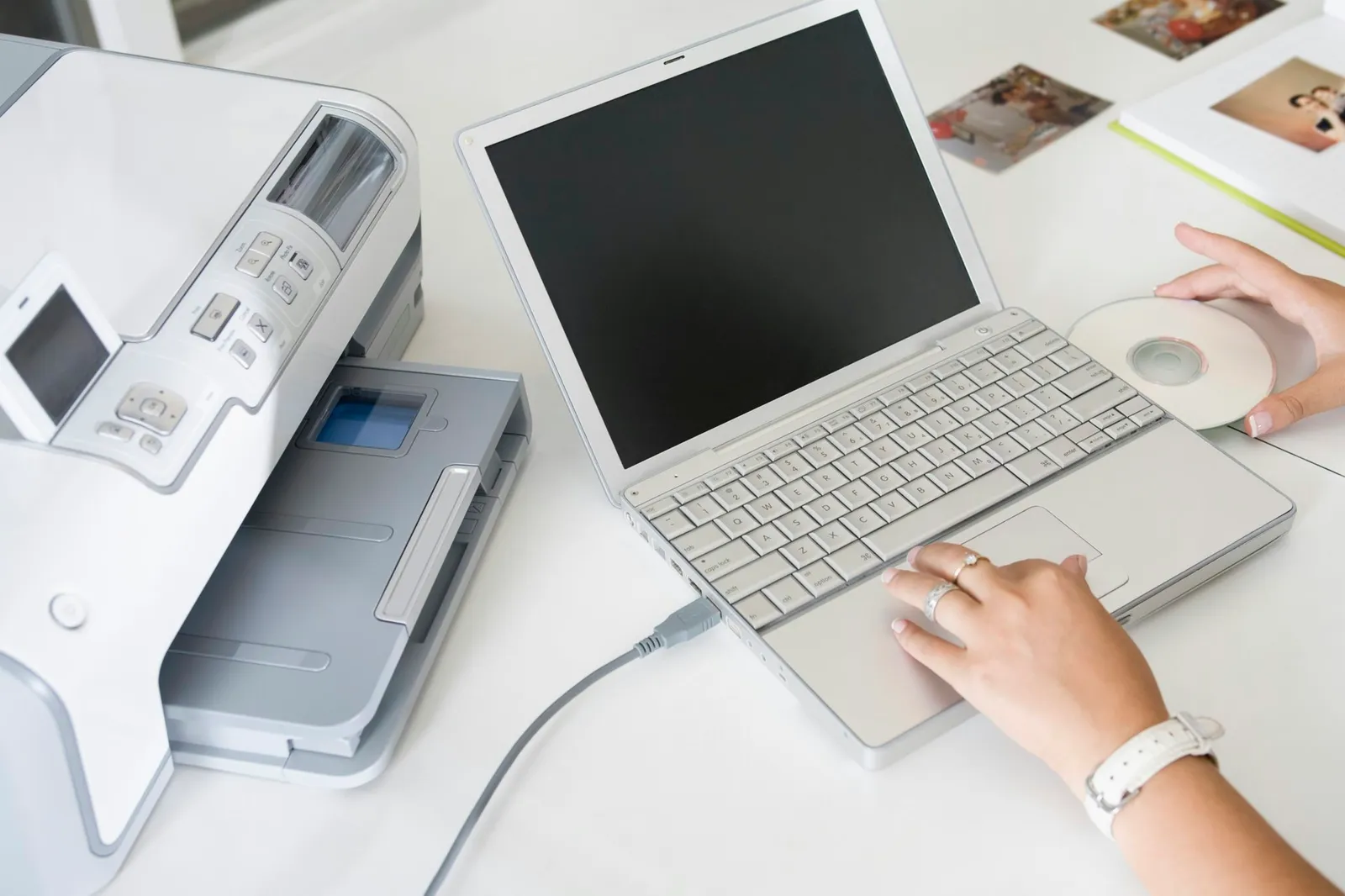 Hands with laptop computer and printer