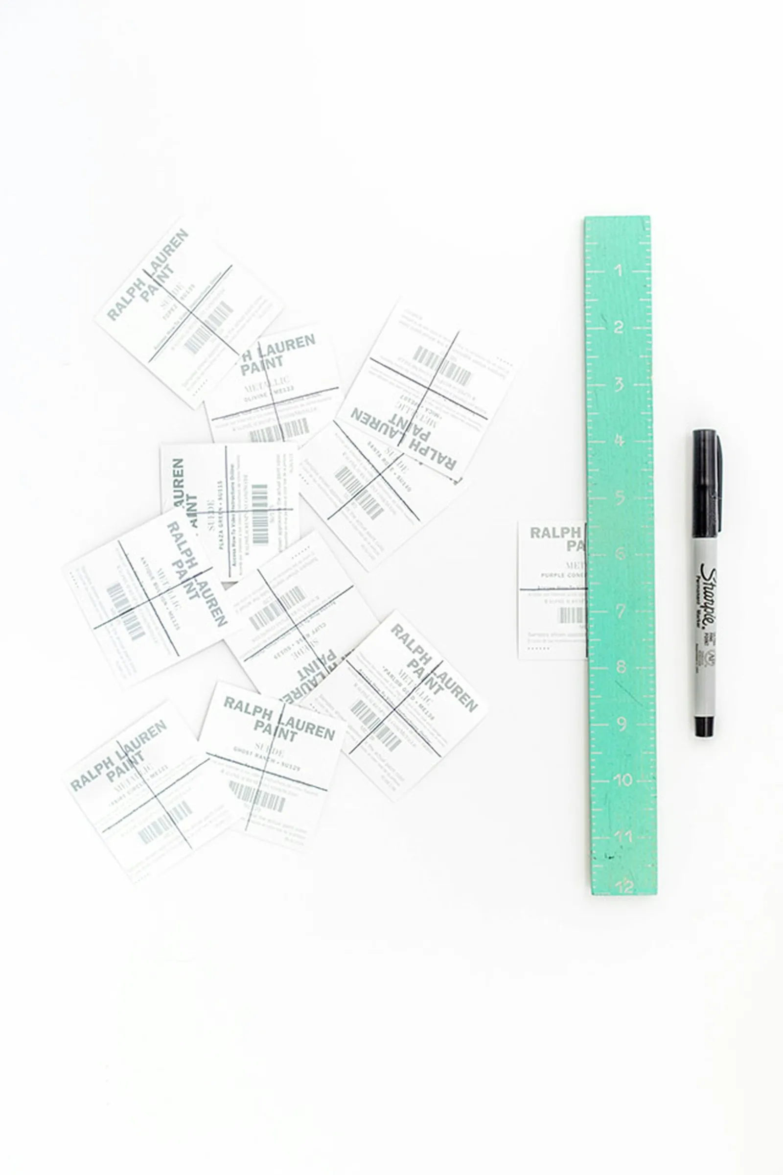Use a straight edge and marker to divide the paint chips into even sections.