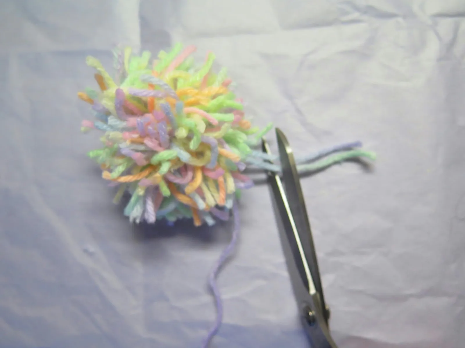Cutting off excess yarn except for the tail.