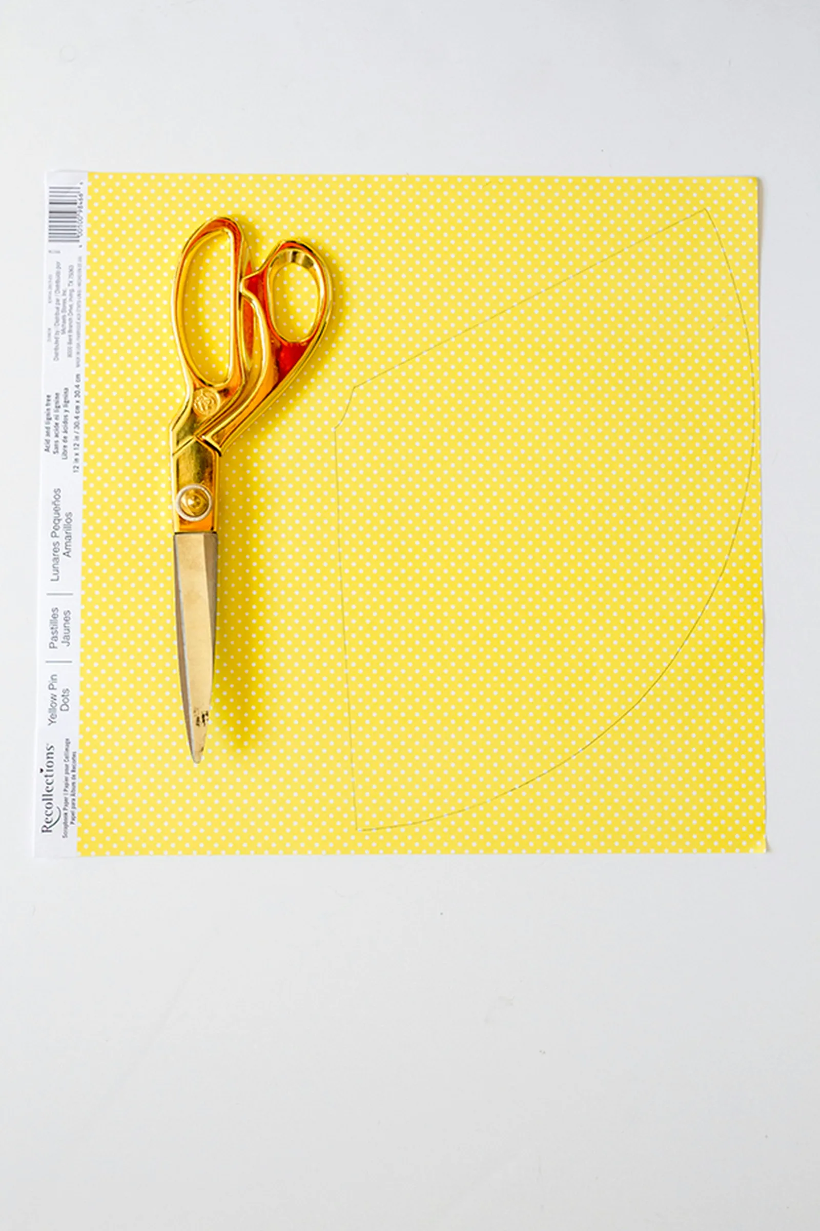 Trace the paper hat template on a piece of patterned paper and glue it on top of the white paper form.