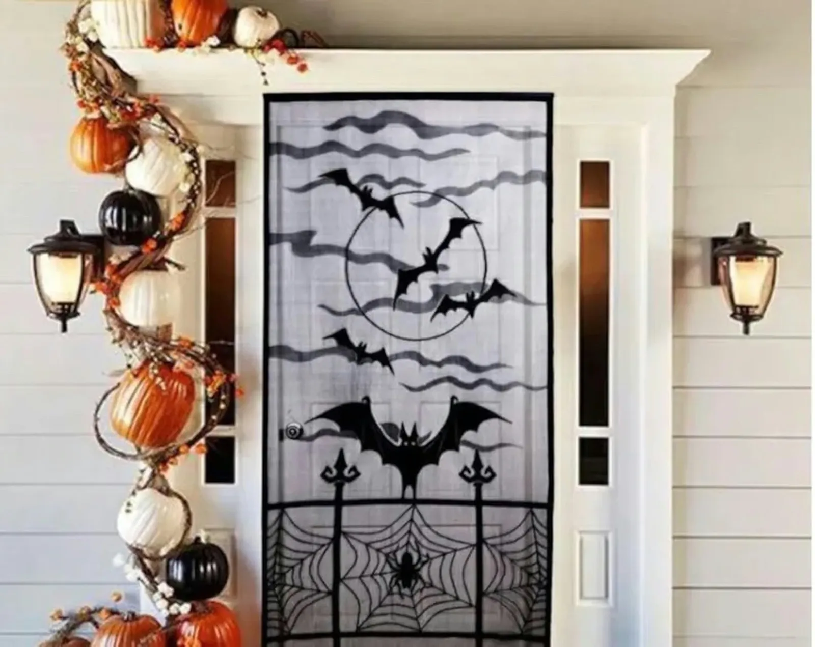 Halloween Door Curtain from Etsy. It's translucent and has images of flying bats and spiderwebs on it. It hangs over your front door.