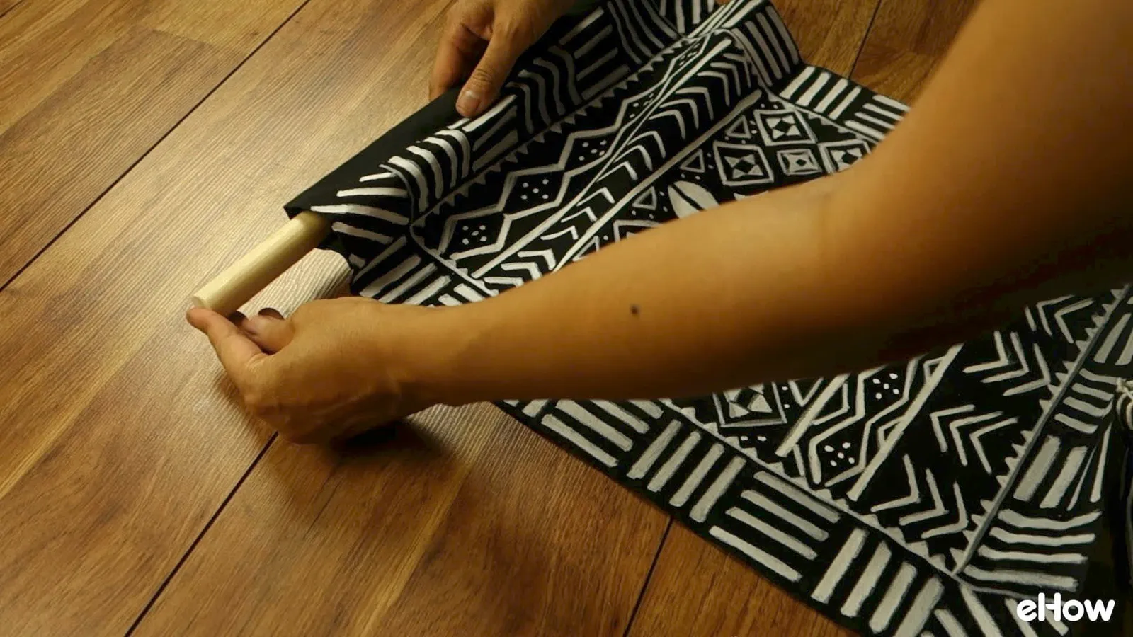 Preparing to hang DIY mudcloth-inspired wall hanging.
