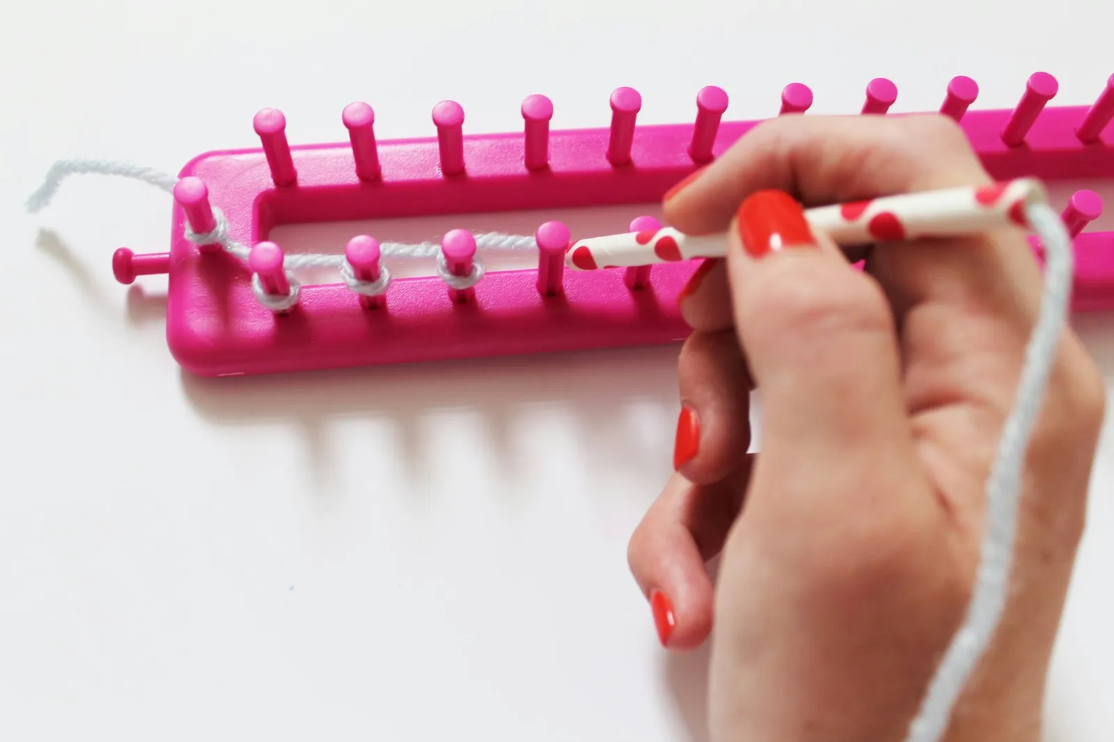 Wrapping the loom pegs.