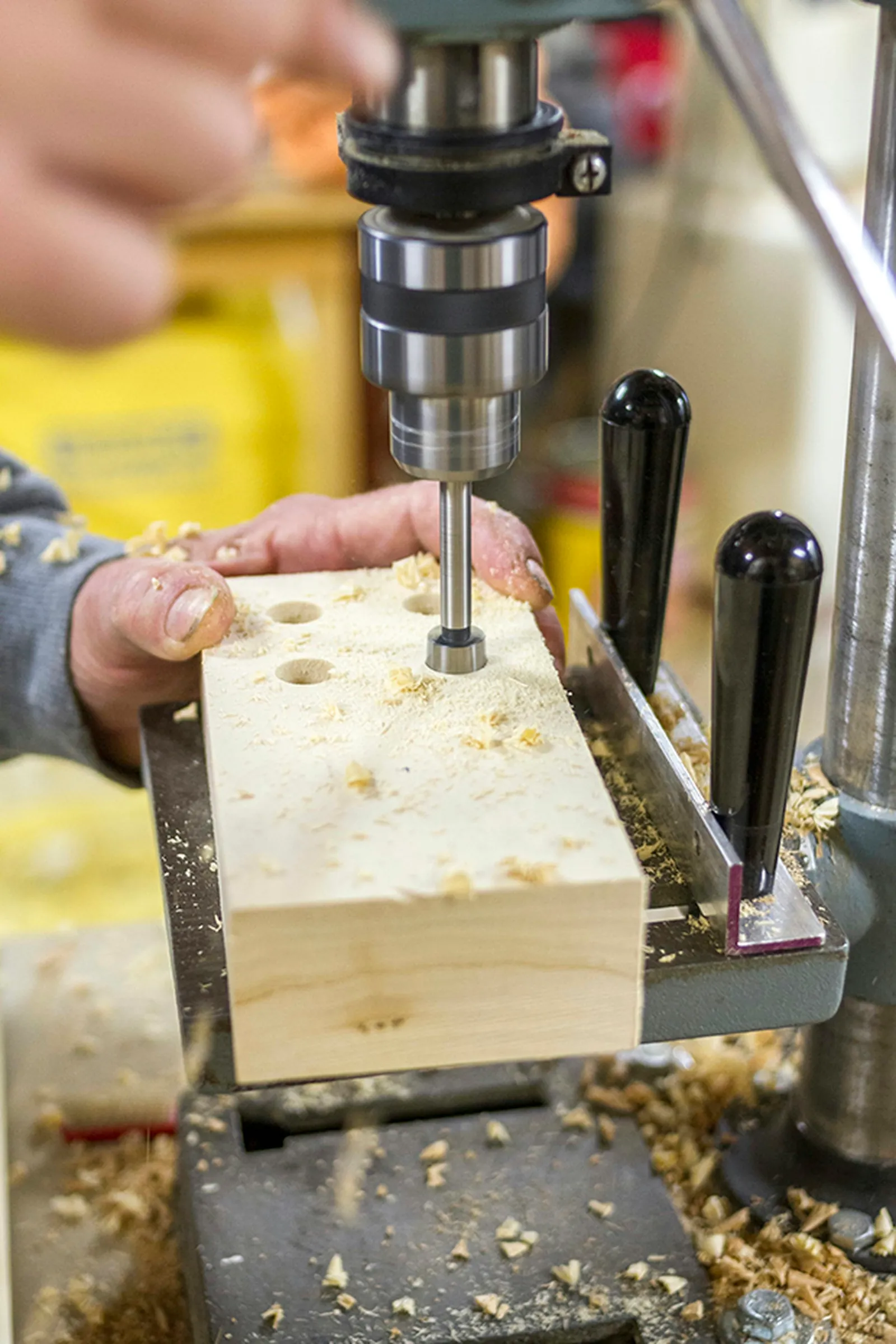 Drill small holes into the top of the wood block for the brushes to go into.
