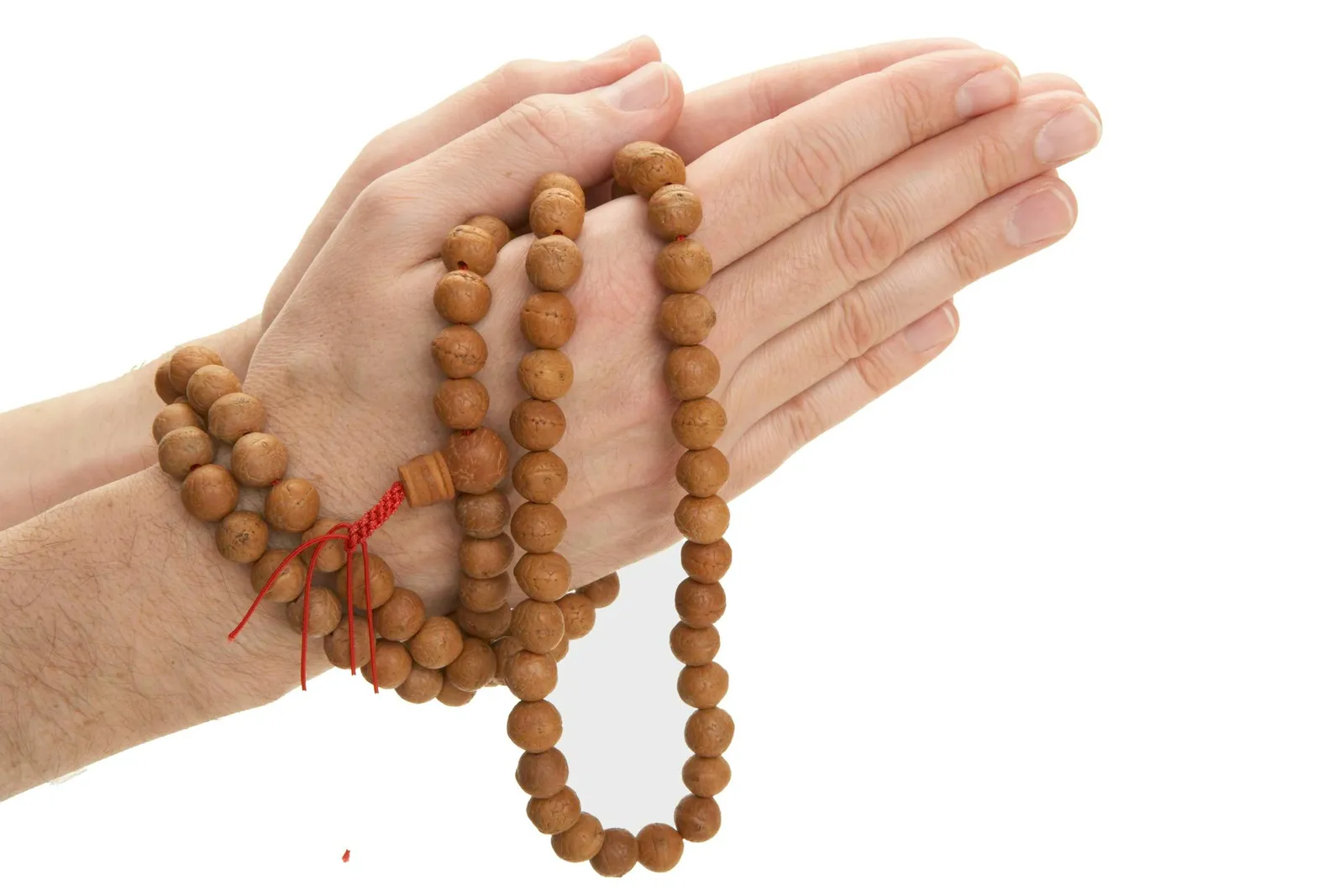 Man holding Buddhist prayer beads, close-up of hands