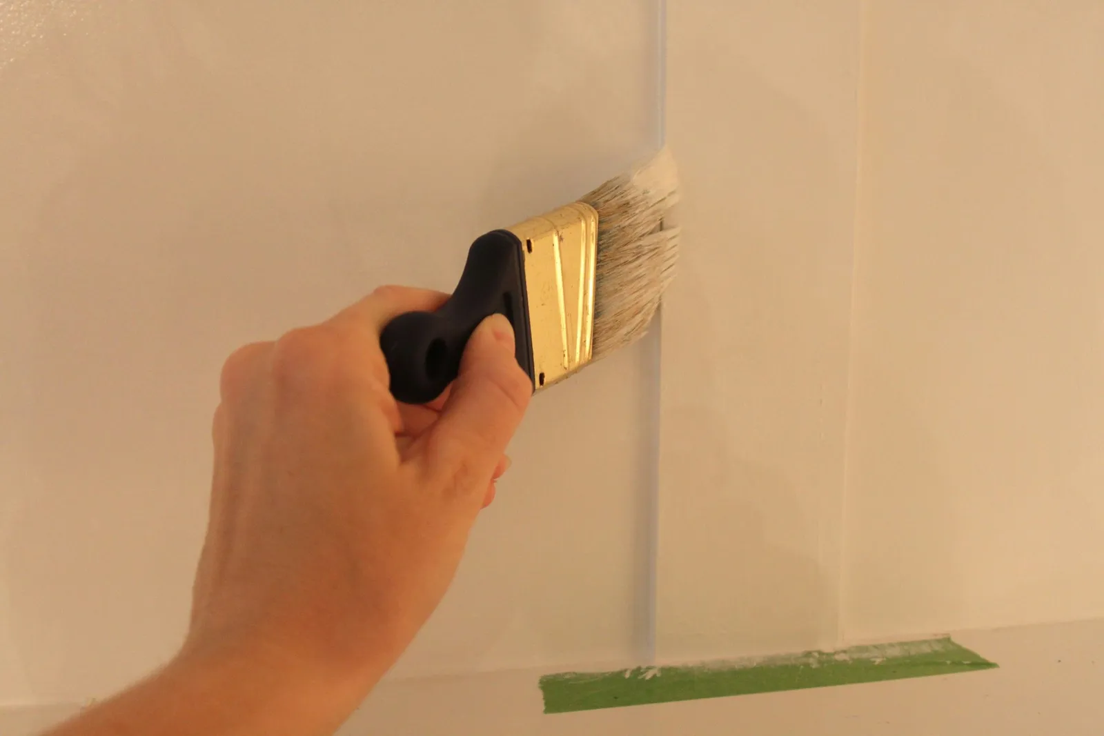 Painting the wall with a brush